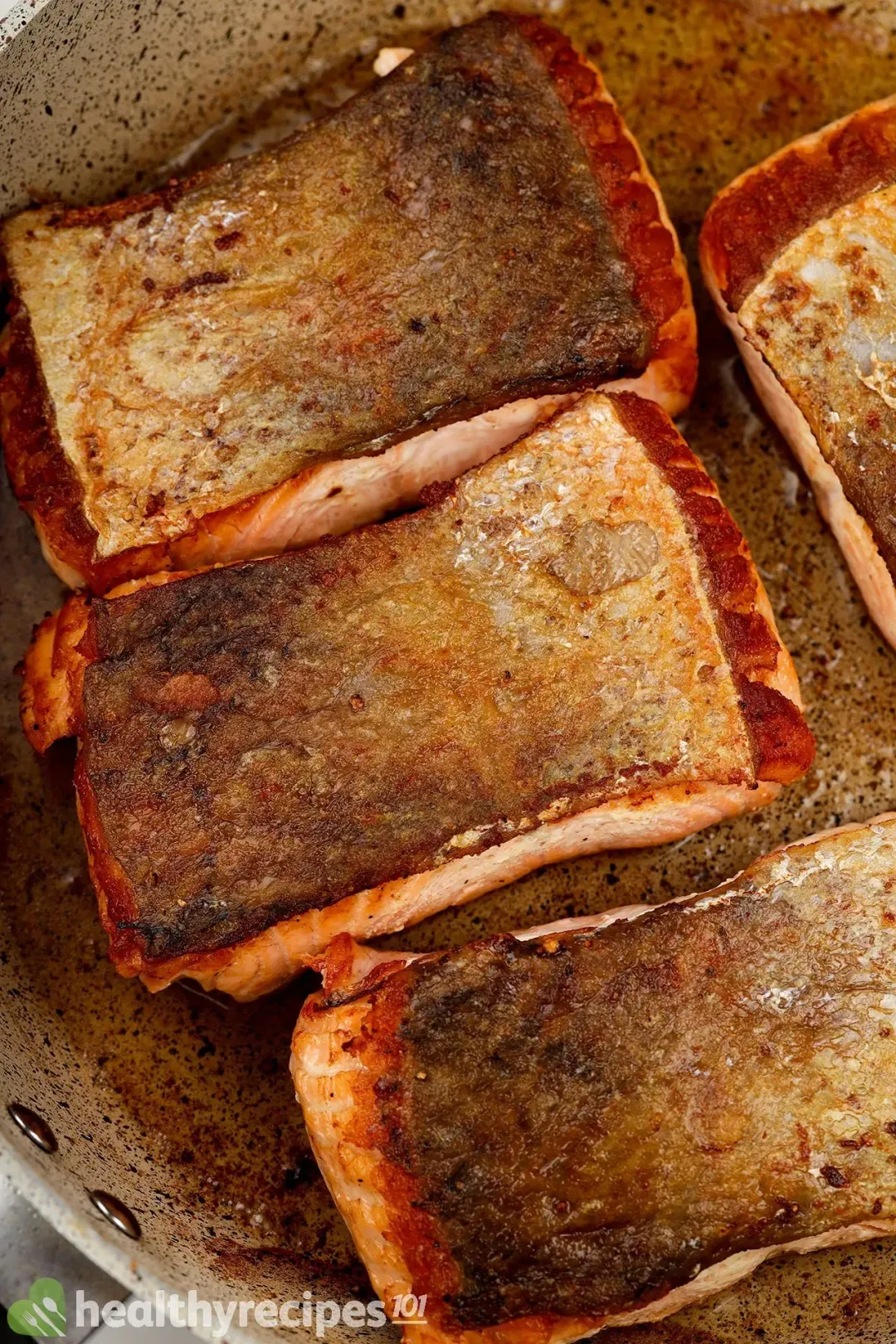 A non-stick pan of crispy-skin salmon