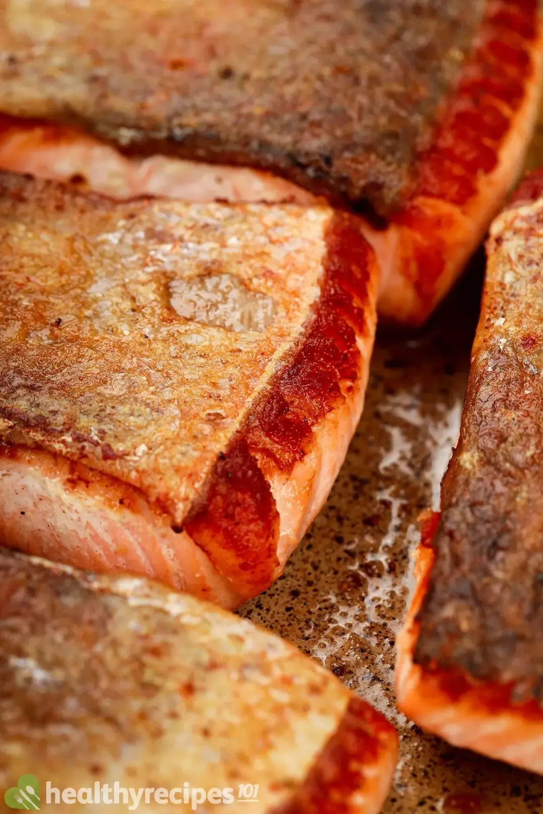 A close-up picture of crispy-skin salmon cooked on a non-stick pan