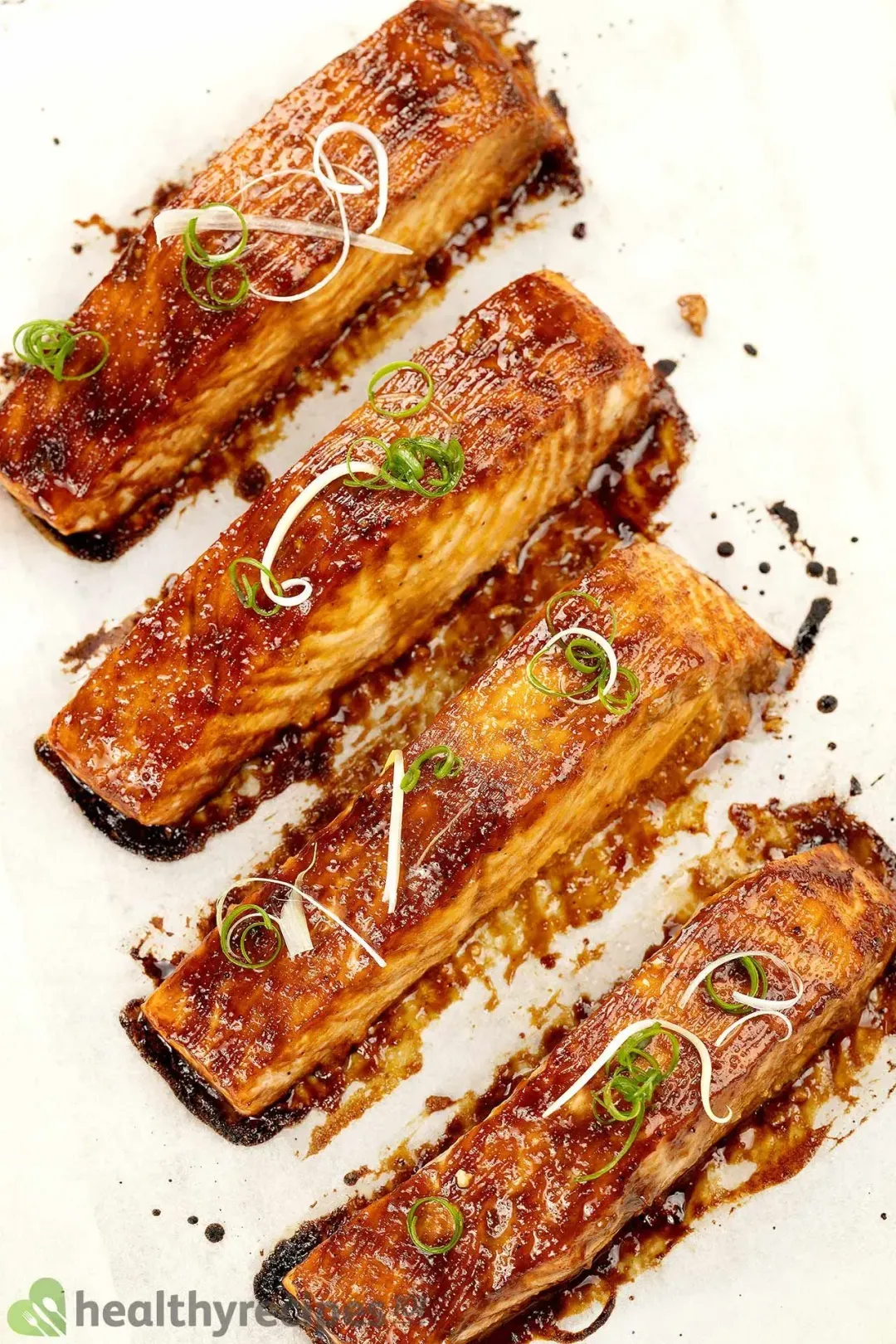 Four pieces of salmon fillets covered in a glossy brown miso sauce