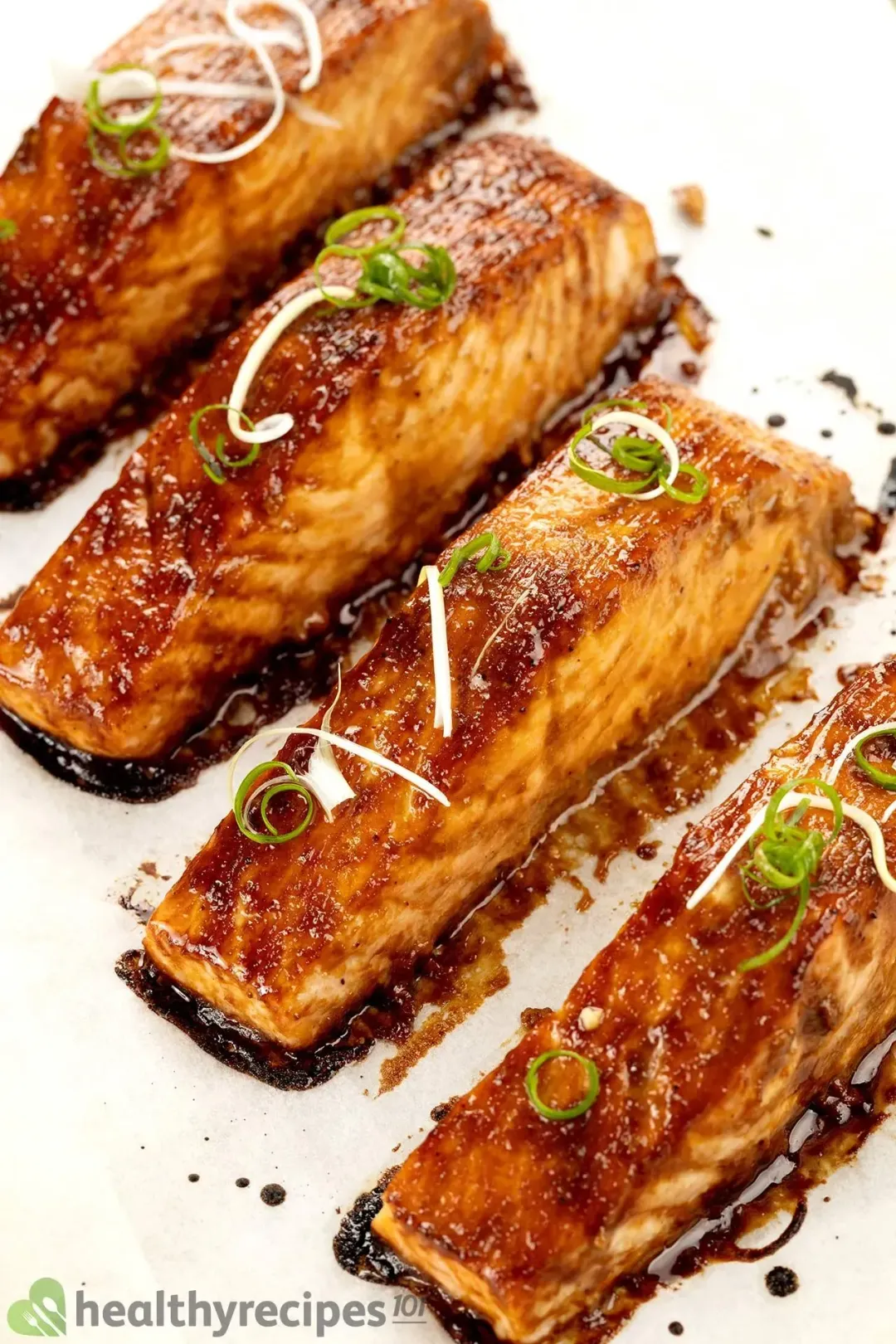 Four pieces of salmon fillets covered in a glossy brown miso sauce