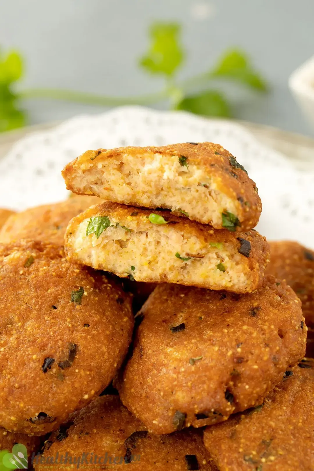 A stack of salmon patties, with one broken in half put on top