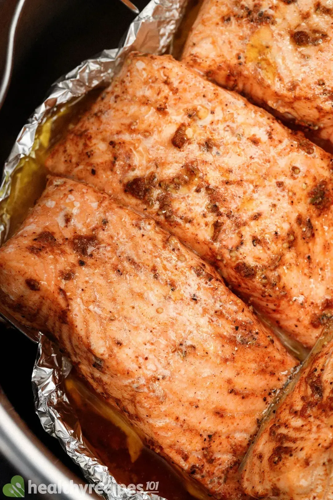 Well-seasoned salmon fillets wrapped in aluminium foil and placed in an Instant Pot waiting to be cooked
