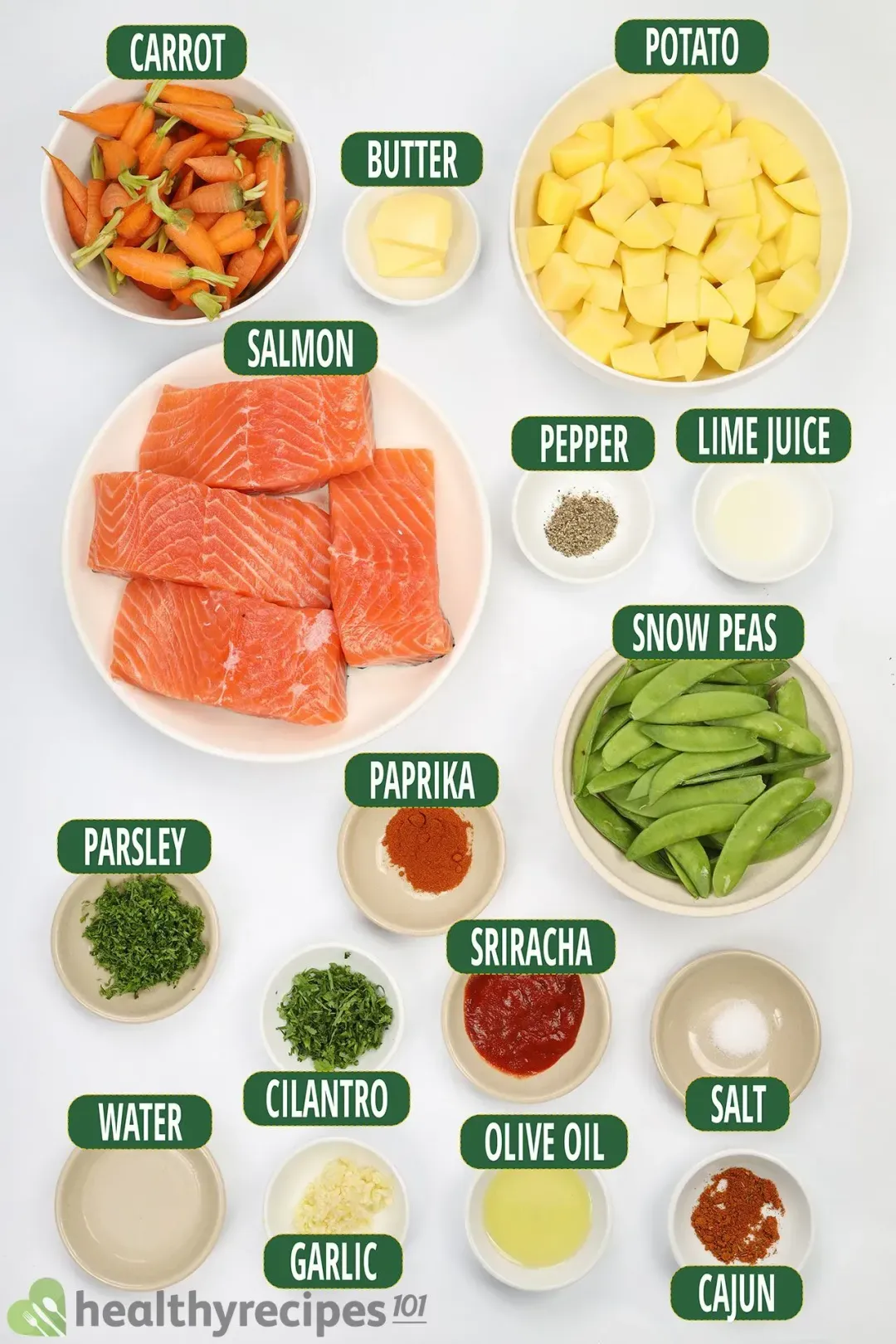 Ingredients for this Instant Pot salmon: boneless salmon fillets, baby carrots, cubed potatoes, snow peas, chopped parsley and cilantro, minced garlic, butter, Cajun seasoning, and other spices and condiments