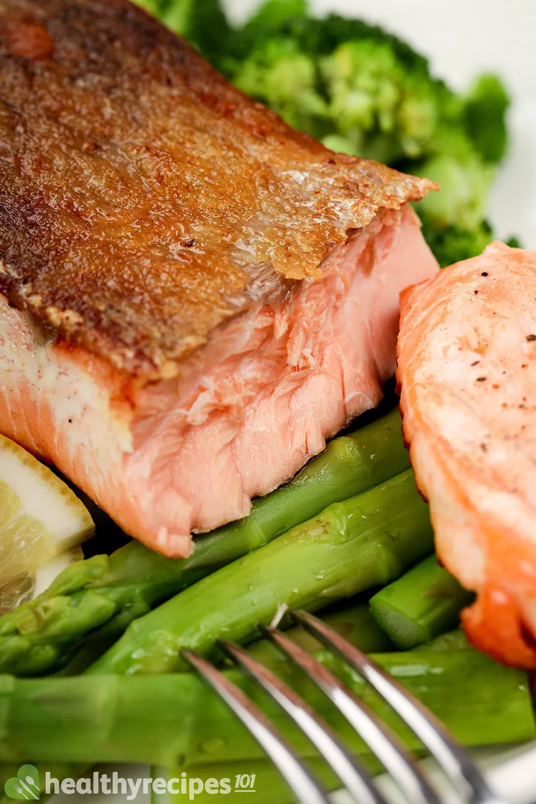 cooked salmon bed on asparagus
