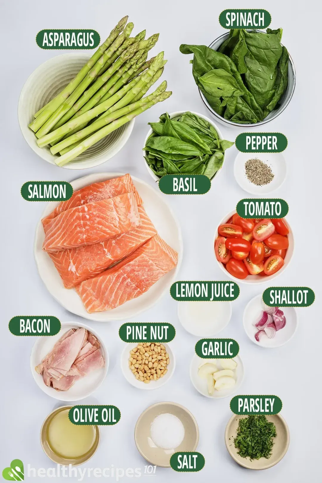 Ingredients for this salmon pesto: boneless salmon fillets, bacon, asparagus, spinach, basil, halved cherry tomatoes, shallot, garlic, pine nut, lemon juice, and other spices and herbs