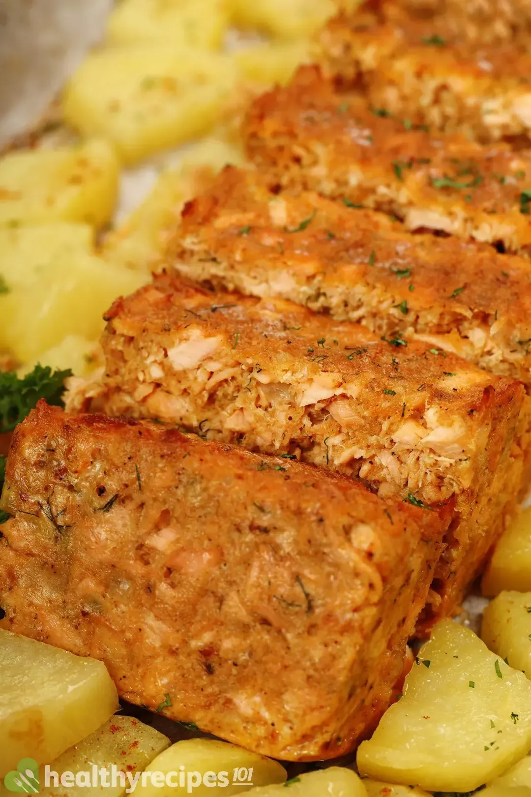 Salmon cakes baked to golden perfection and covered in potato cubes