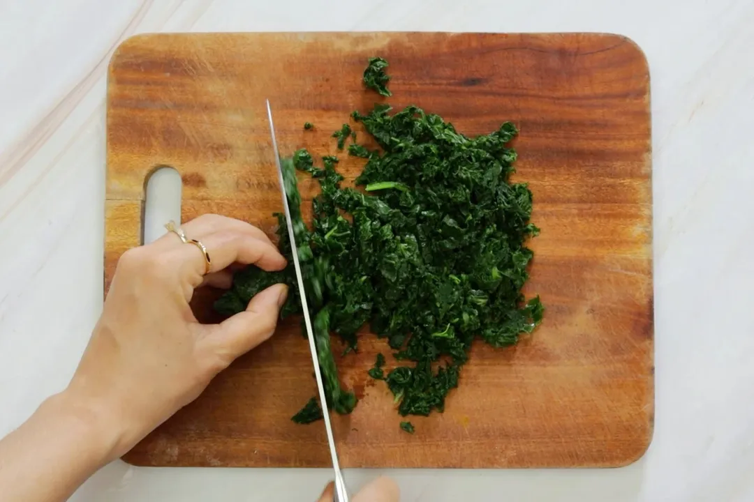chopping kale on a cutting board