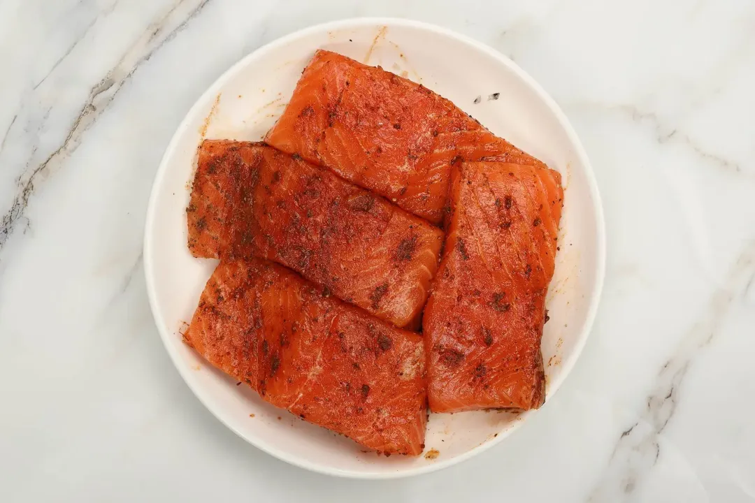 A picture of well-seasoned salmon fillets placed on a platter
