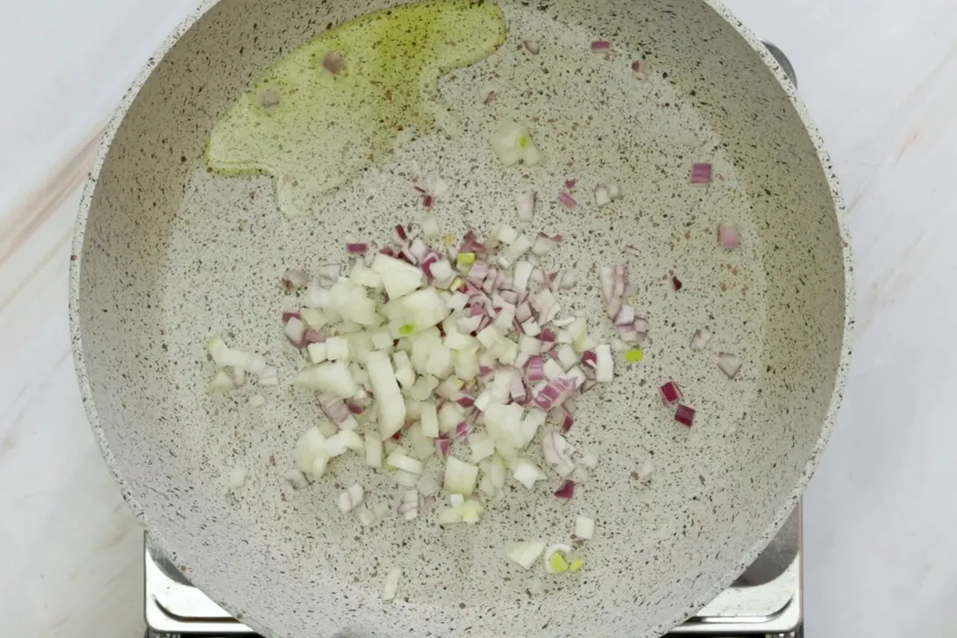 sauteeing minced garlic in a skillet