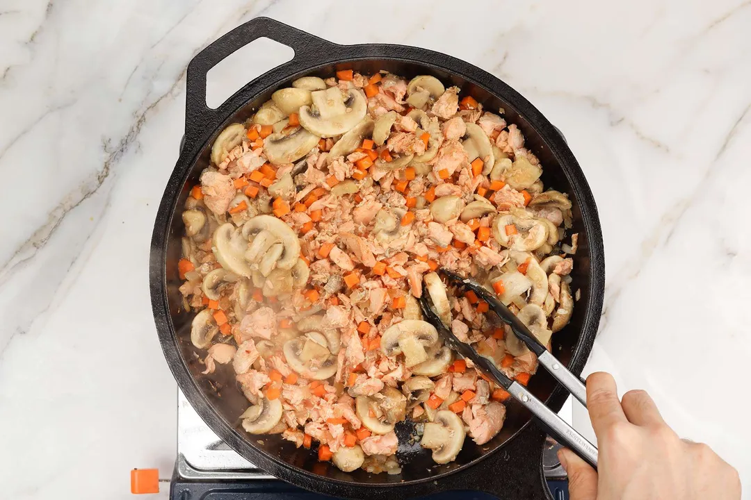 add diced carrot to a skillet of cooked salmon and mushroom