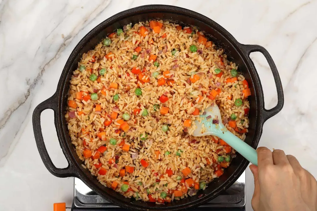 Fried rice with colorful veggie chunks in a cast iron skillet