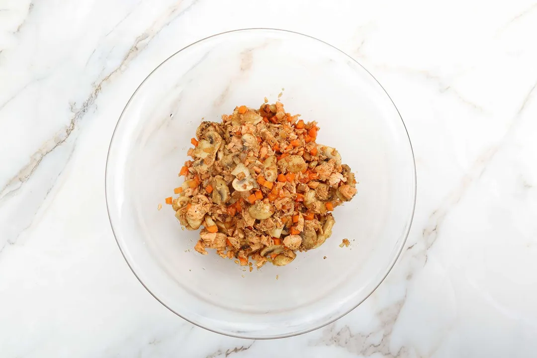 cooked salmon and mushroom, carrot in a glass bowl