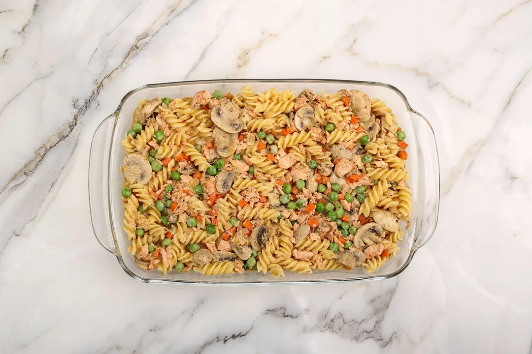 pasta, mushroom and cooked salmon in a baking dish