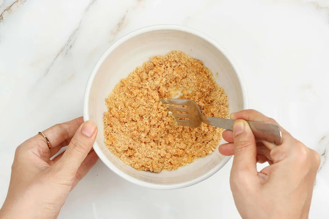 mix panko breadcrumb in a bowl by a fork