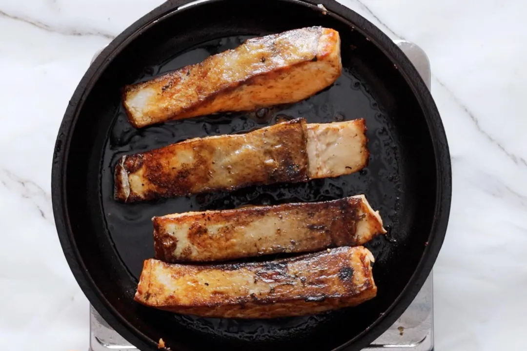 searing salmon in a pan
