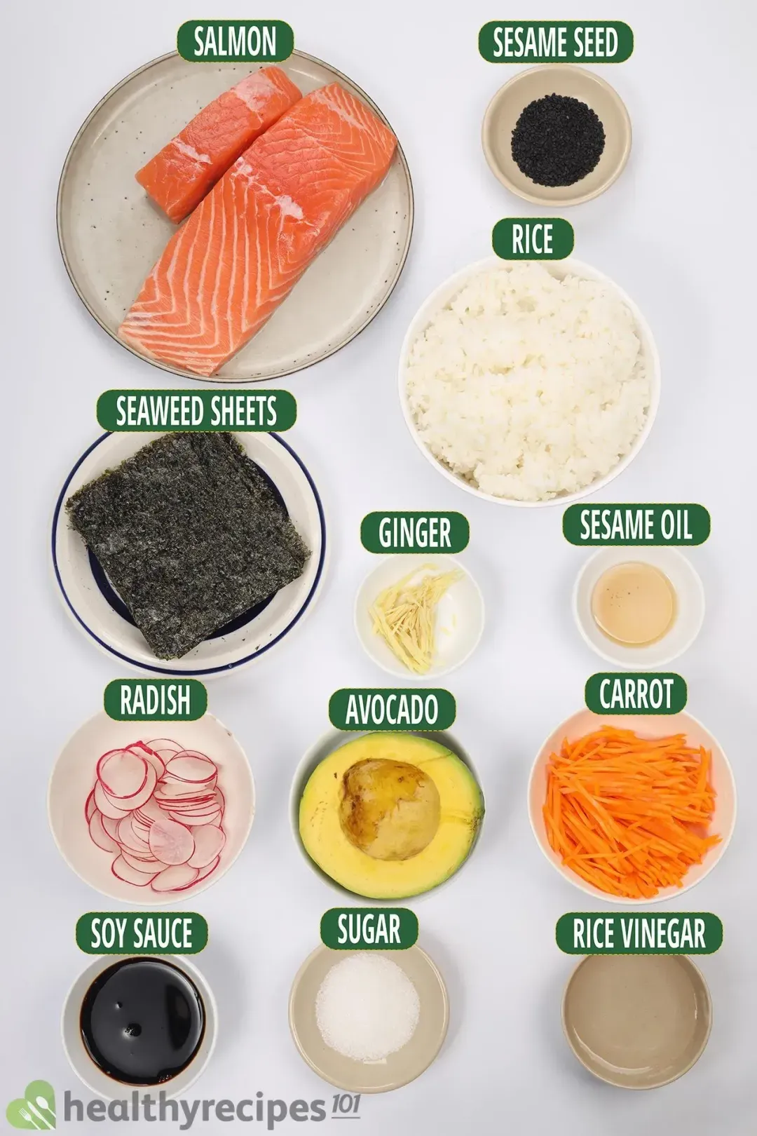 Ingredients in separate bowls: salmon filets, cooked rice, seaweed sheets, soy sauce, and other toppings
