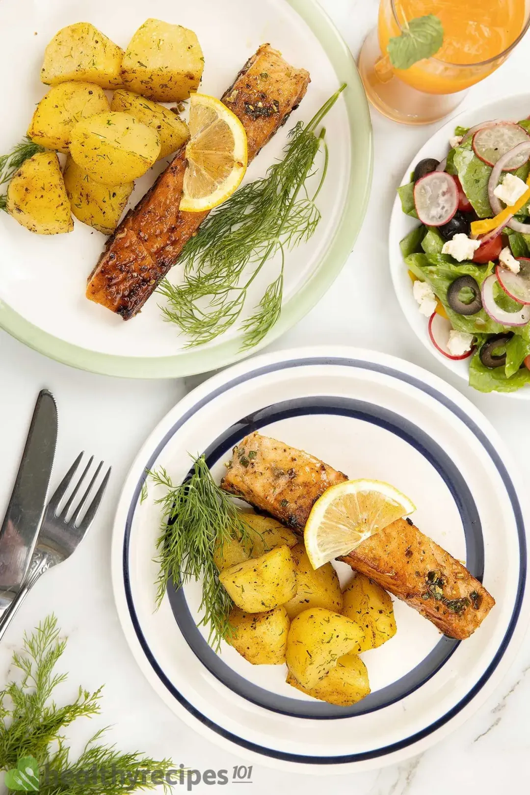 White plates with a salmon Meuniere filet, cooked potato wedges tossed in seasonings, and a dill bundle