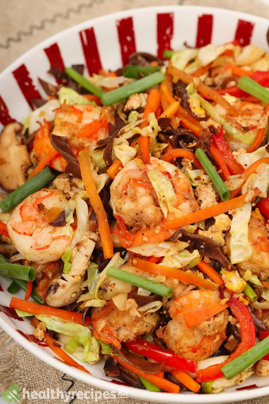 A plated colorful saute of Moo Shu Shrimp, carrot, peppers, and cabages
