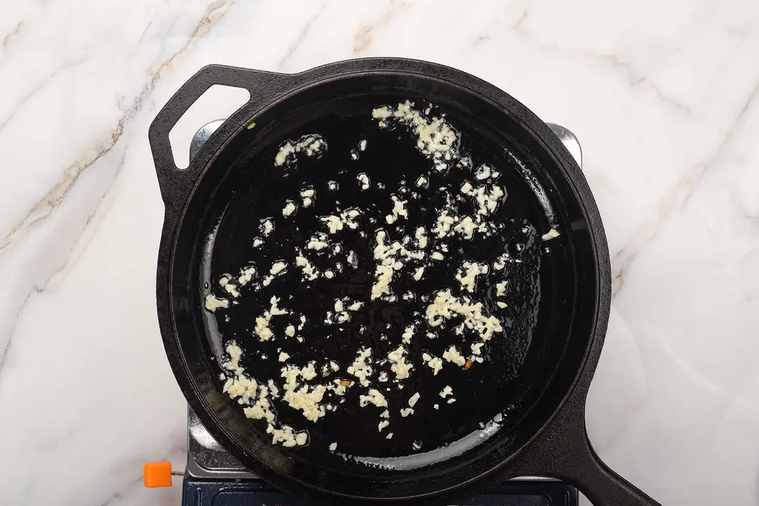 Garlic sauteed in a cast iron skillet