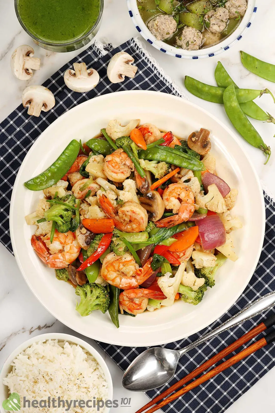 Shrimp chop suey served with cooked white rice on a serving plate