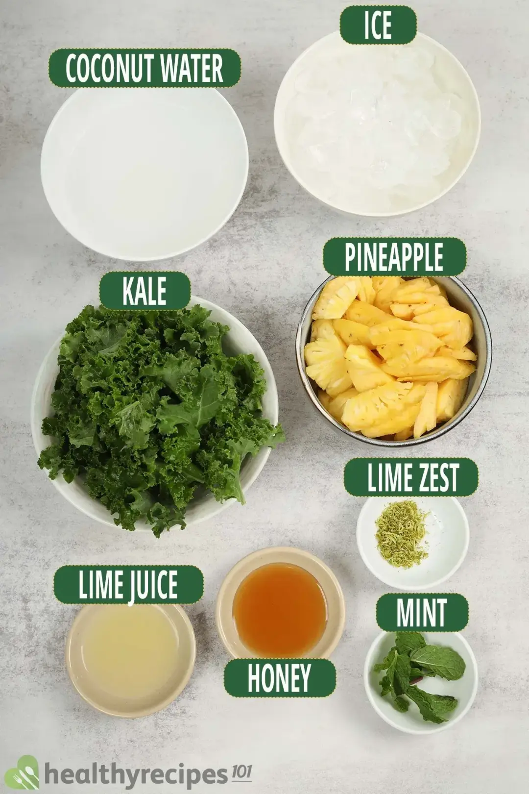 Ingredients for this smoothie: kale leaves, sliced pineapples, coconut water, lime zest, lime juice, honey, mint leaves, and ice cubes.