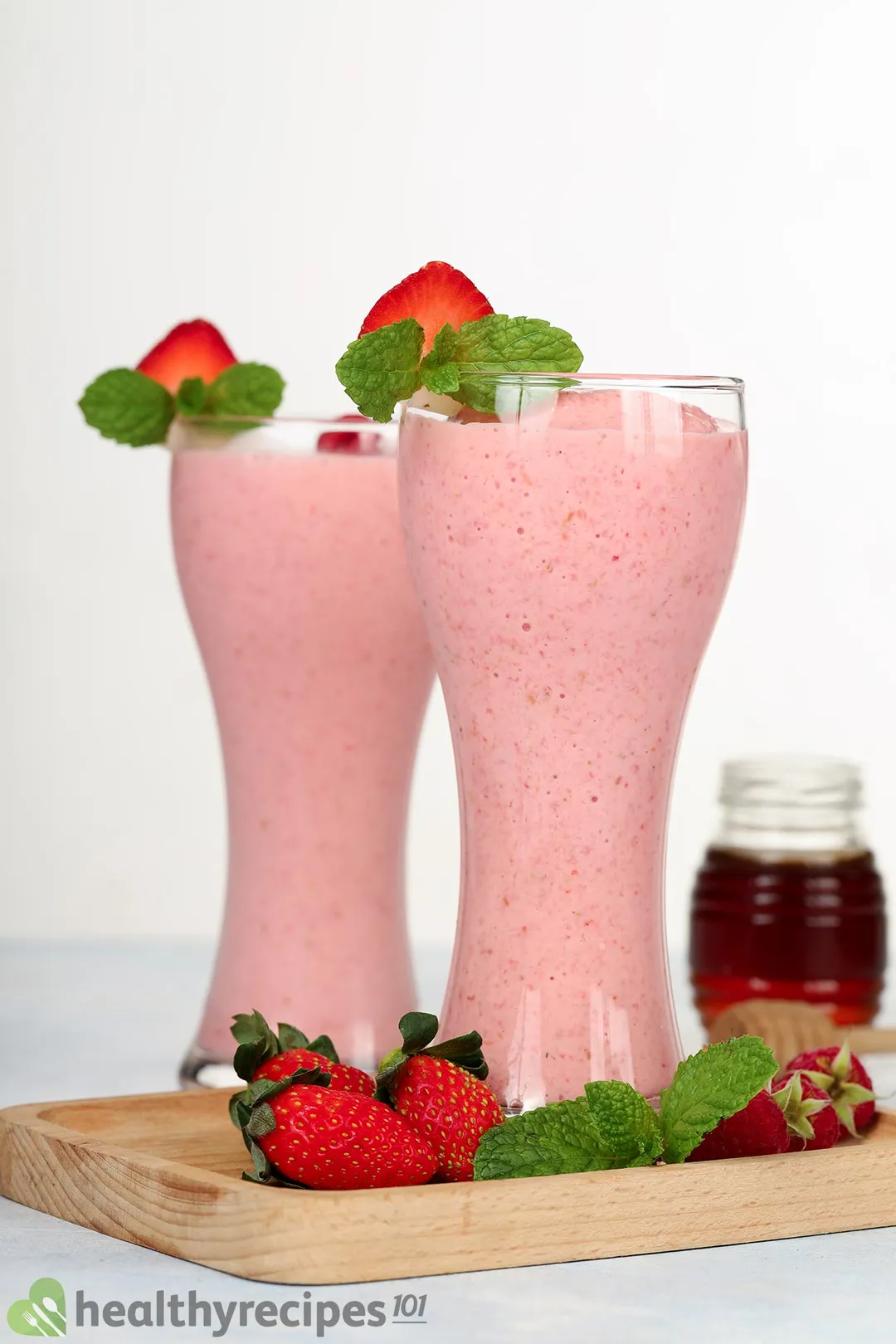 two glasses of strawberry raspberry smoothie on a tray