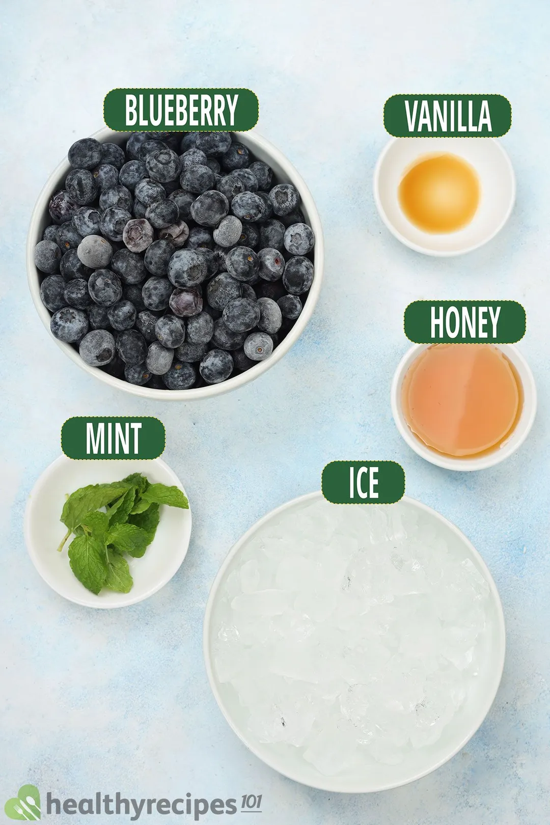 Bowls of blueberry, ice, honey, mint leaves, and vanilla
