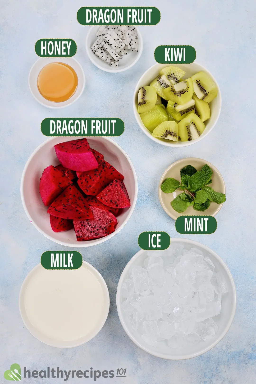 Ingredients for Dragon Fruit Smoothie, including bowls of red dragon fruit, sliced green kiwi, white dragon fruit, and other smoothie essentials.