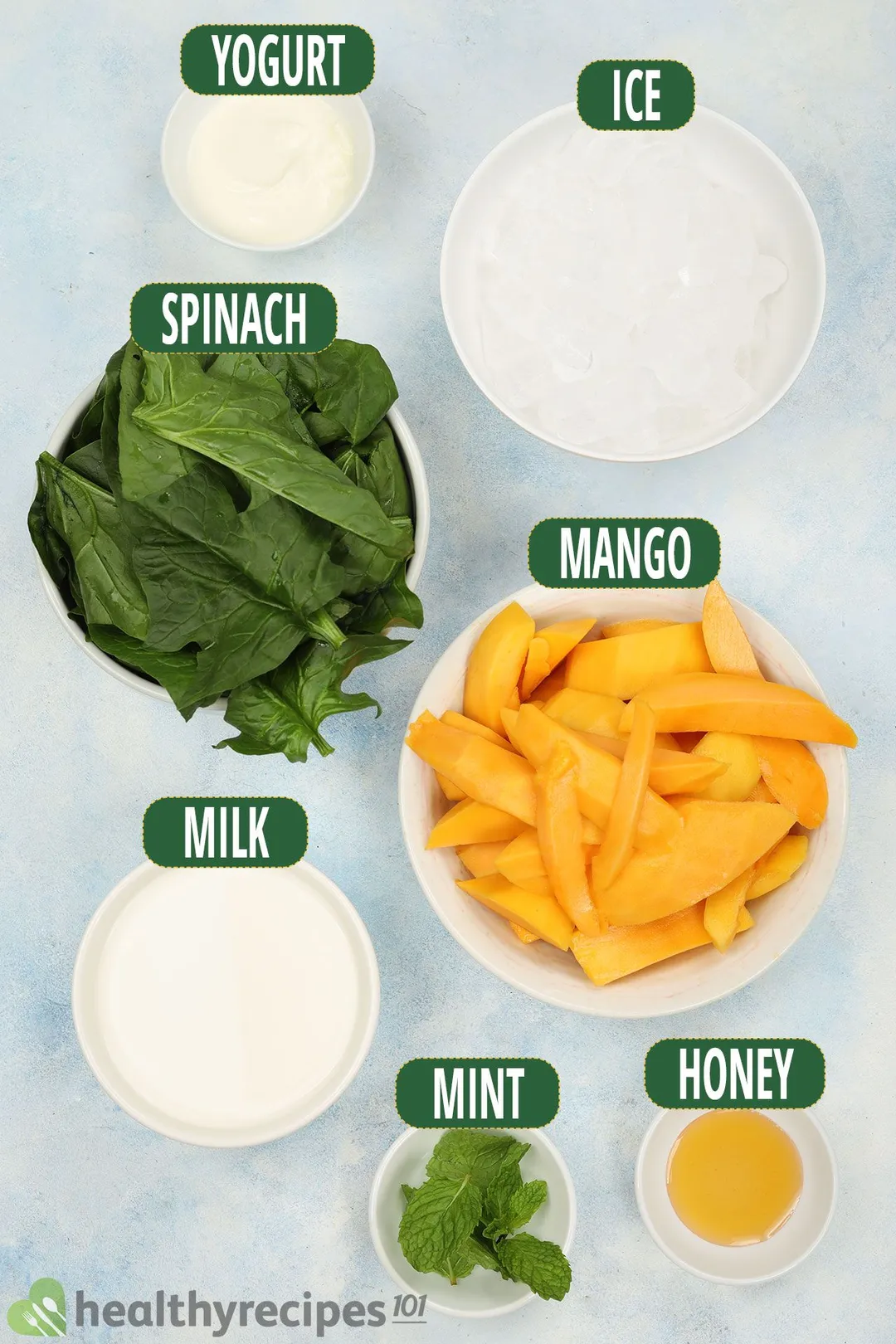 Ingredients for Mango Spinach Smoothie, including fresh spinach, mango wedges, mint leaves, and others.