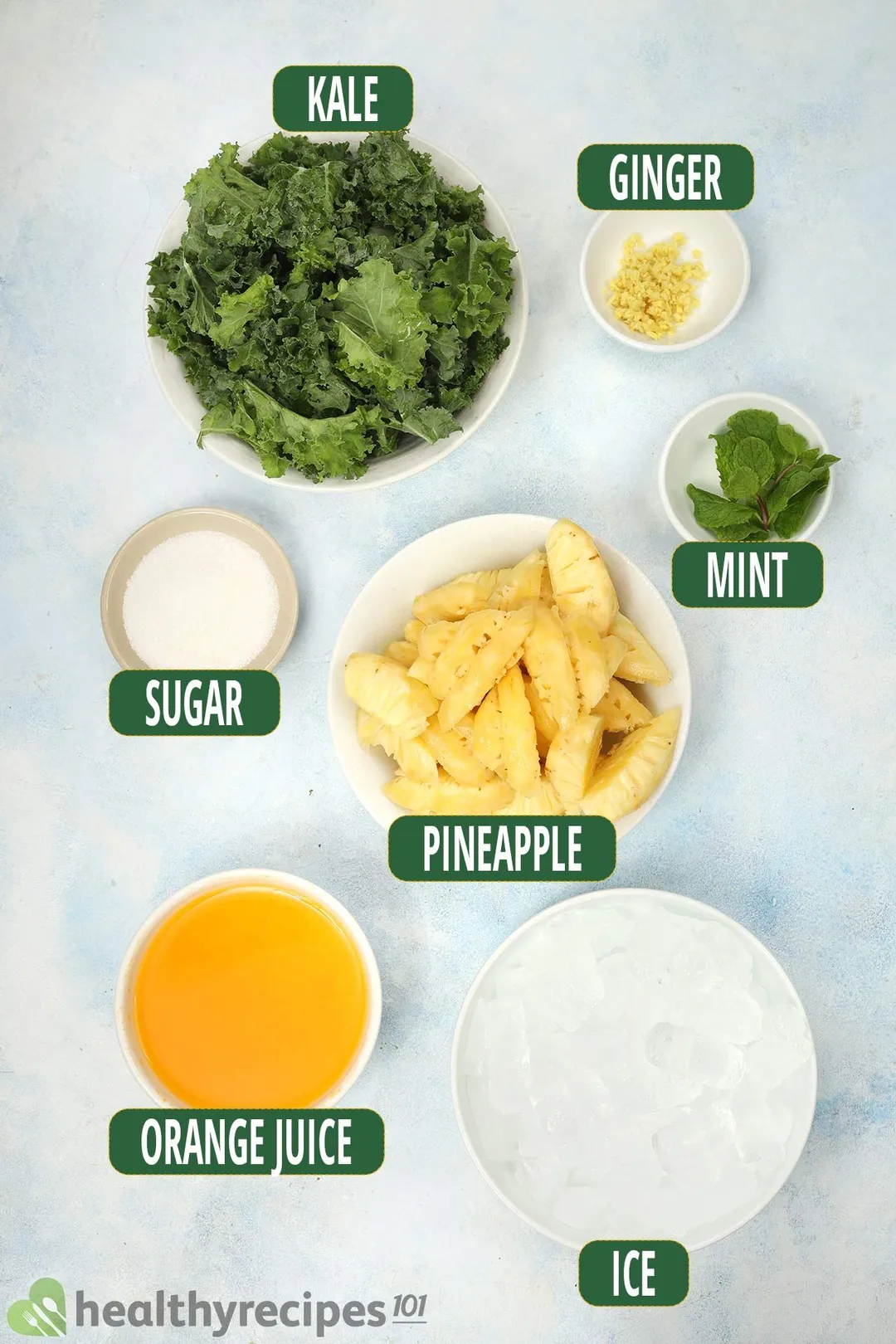 Ingredients for Pineapple Kale Smoothie, including bowls of kale, pineapple slices, and other smoothie essentials.