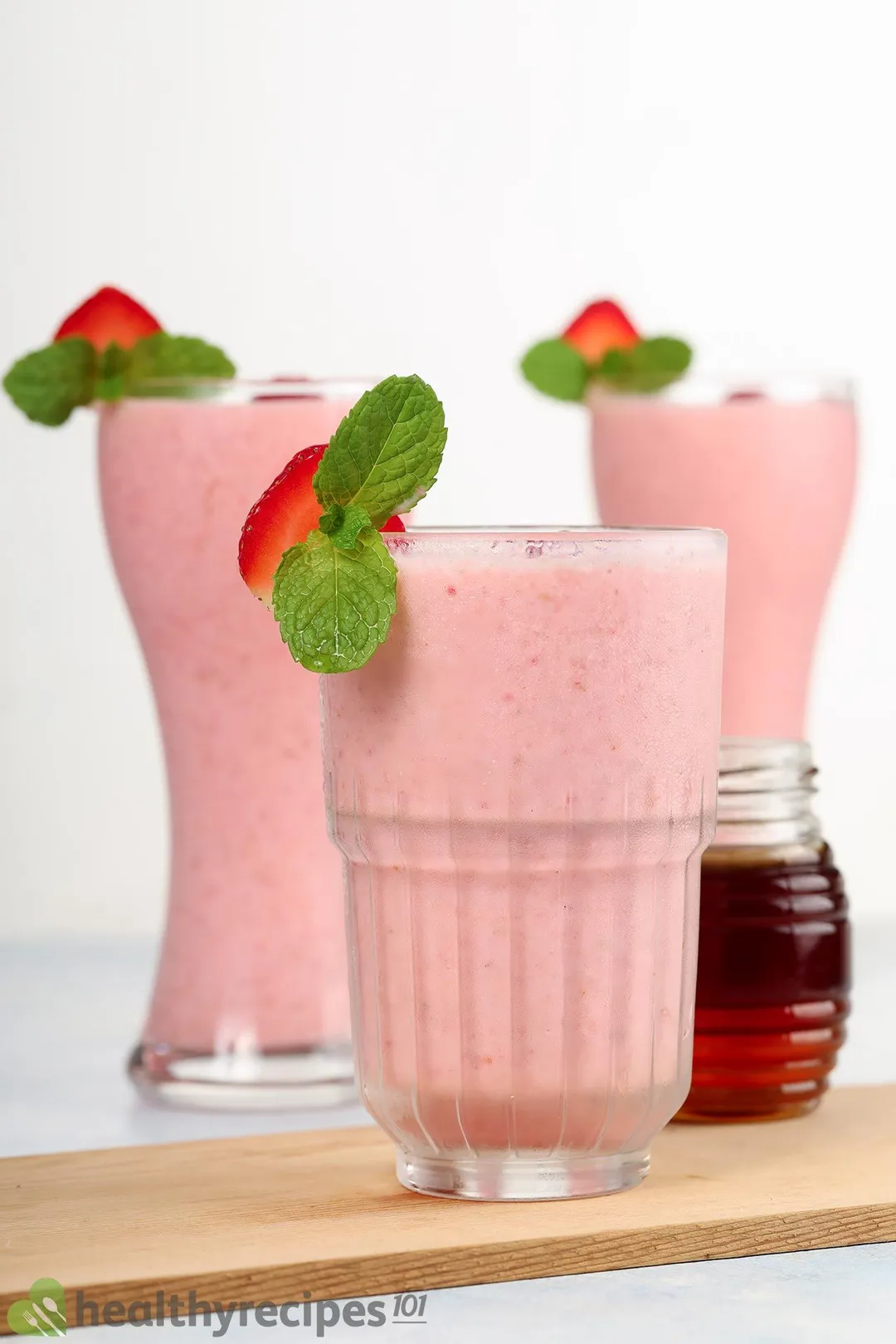 three glass of pink smoothie on a tray