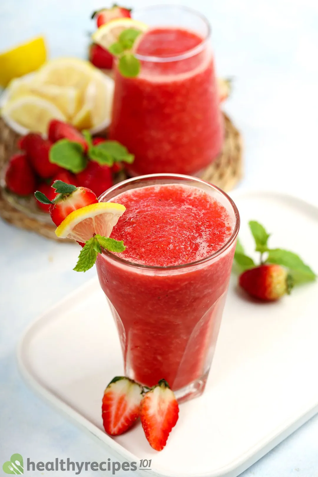 a glass of strawberry lemonade smoothie on a tray