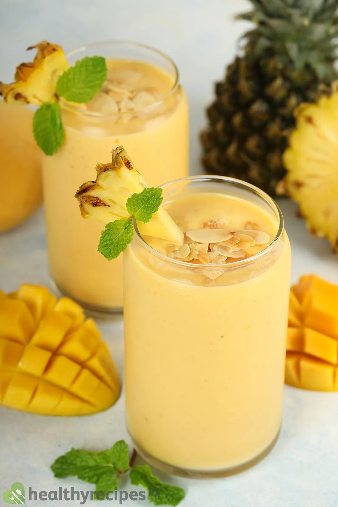 two glasses of mango pineapple smoothie