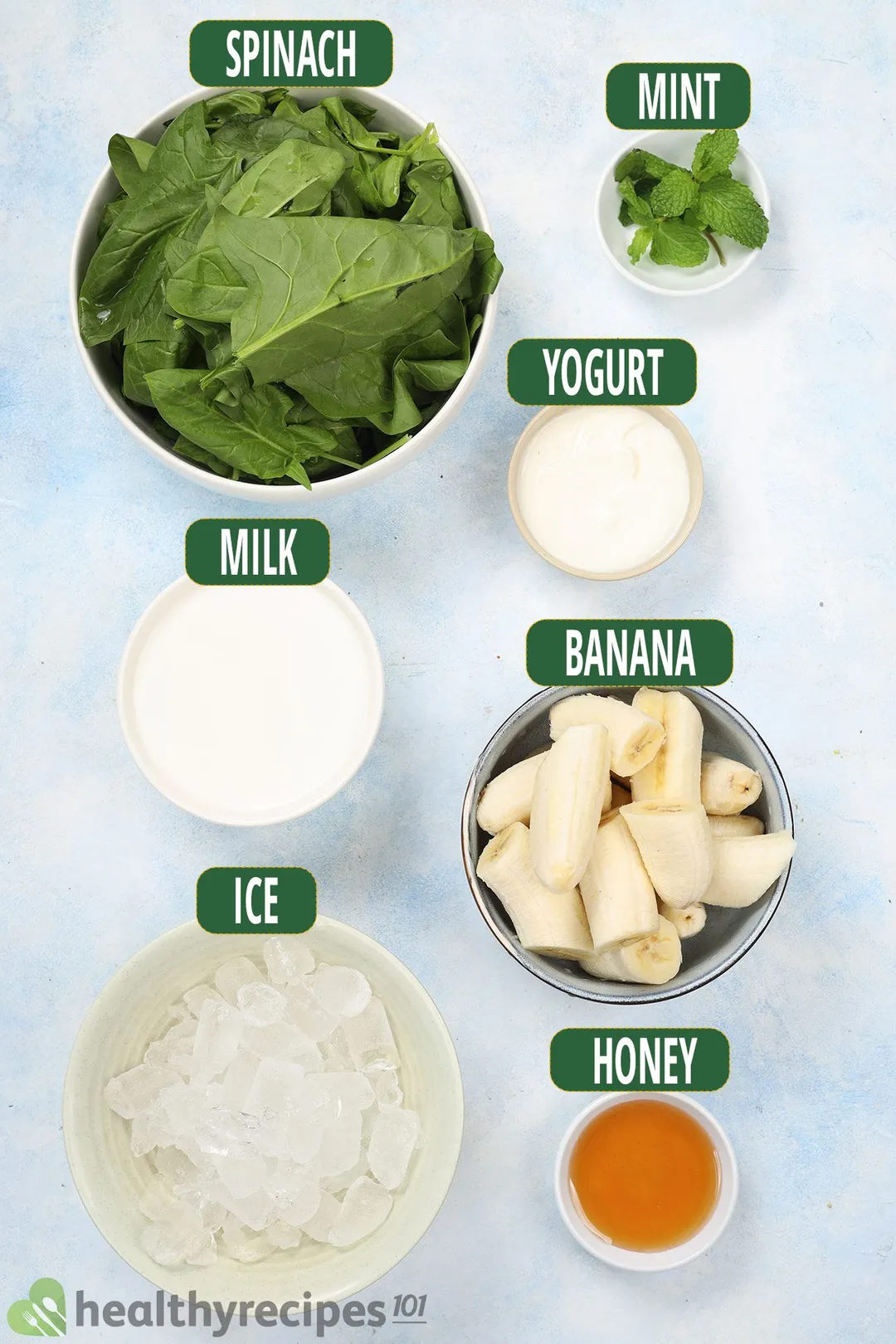 ingredients for Spinach Banana Smoothie: bowls of spinach, banana, milk, yogurt, honey and ice