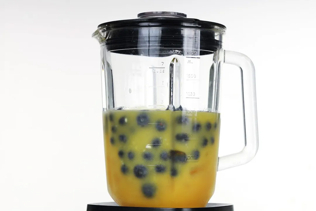 blueberries, orange juice in a blender pitcher