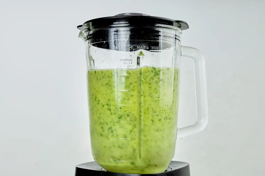 blended pineapple green smoothie mixture inside a blender