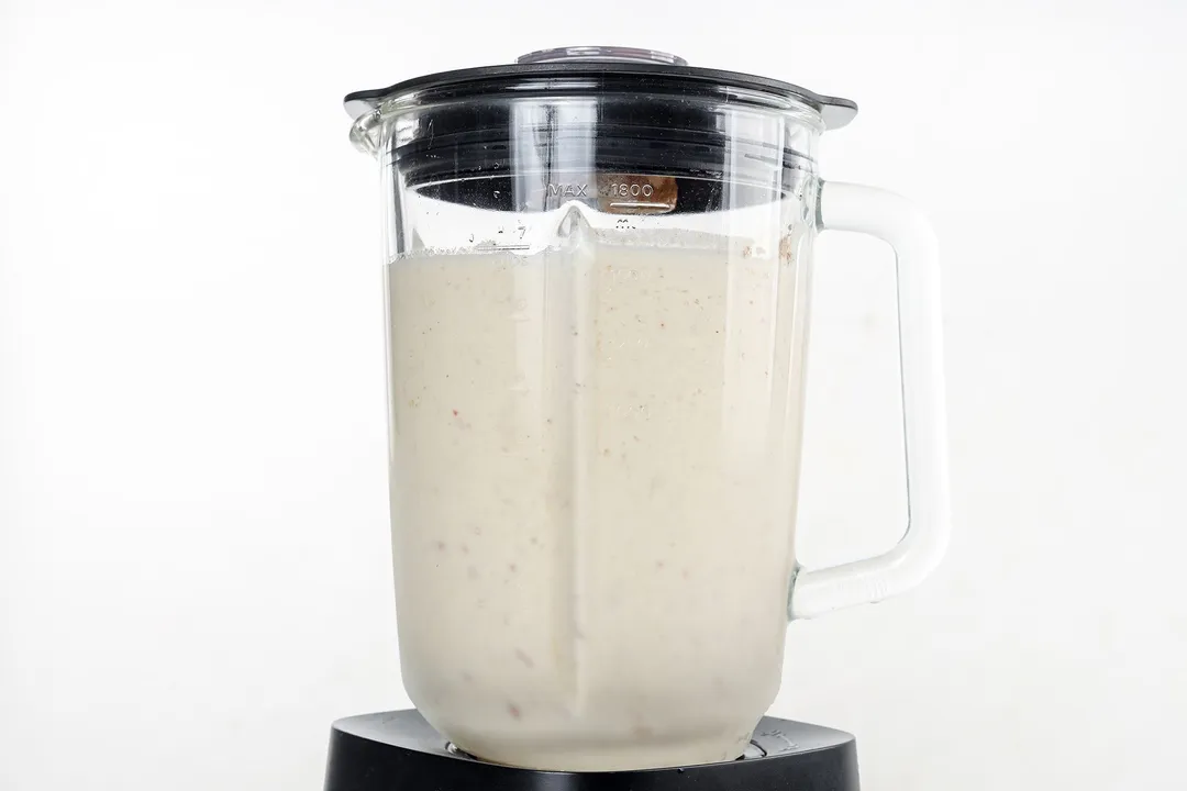 front shot of a blender pitcher with apple pie smoothie in it