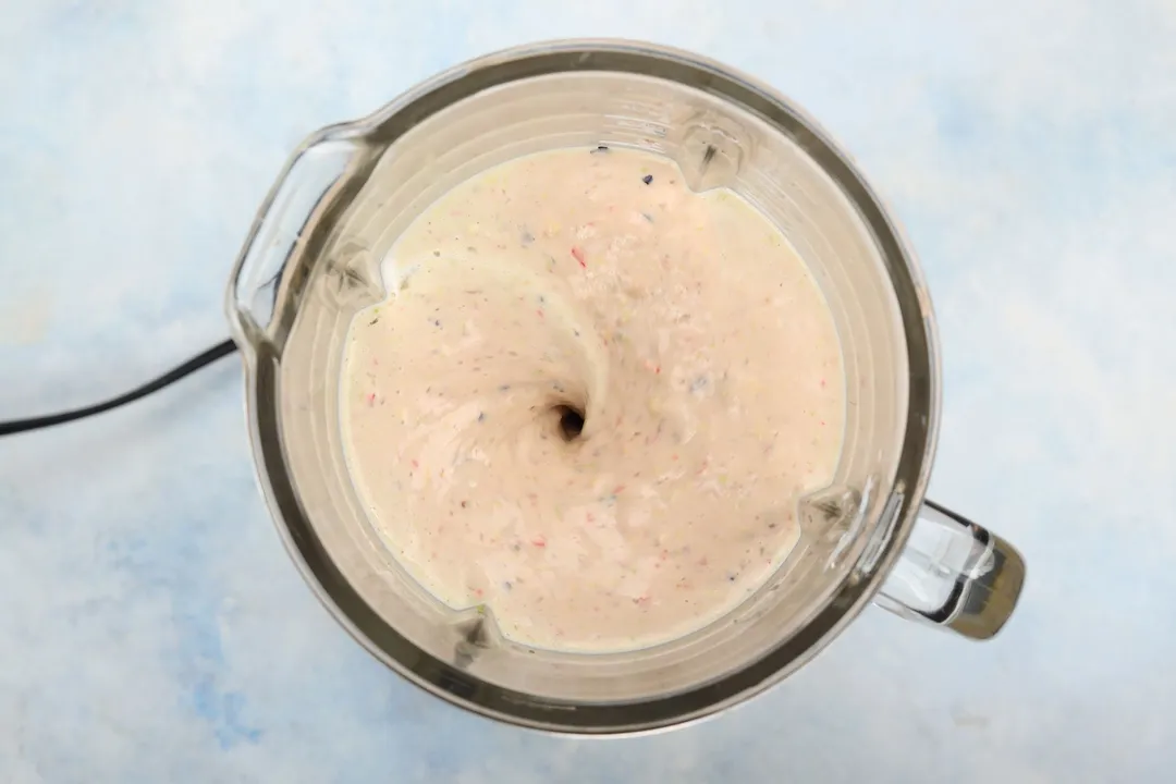 top view of a blender pitcher of avocado berry smoothie