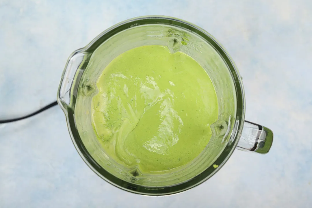 top view of a green smoothie in a blender pitcher.