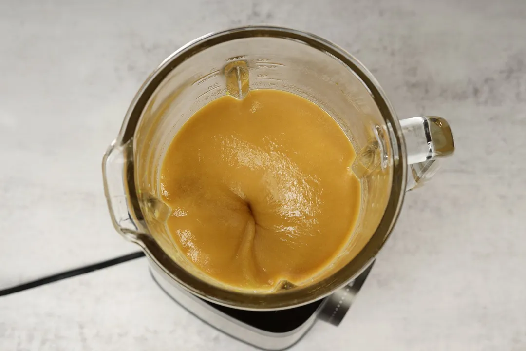 top view of a blender blending avocado papaya smoothie