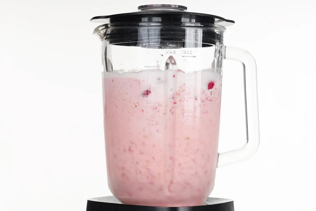 blending pink liquid in a blender pitcher