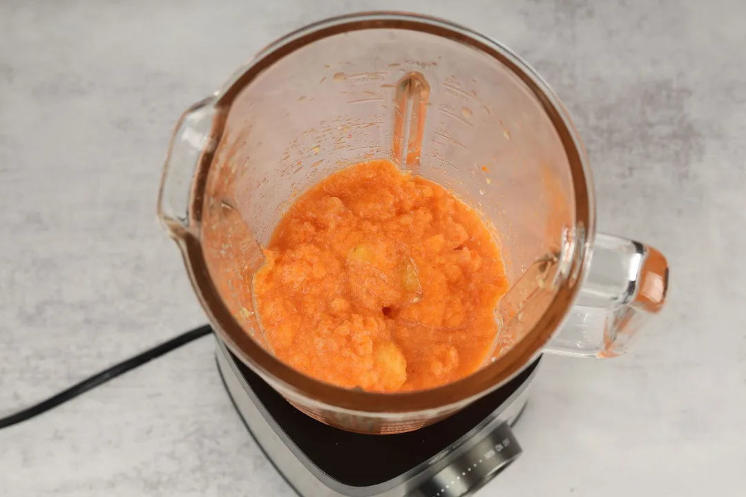 top view of a blender blending carrot smoothie