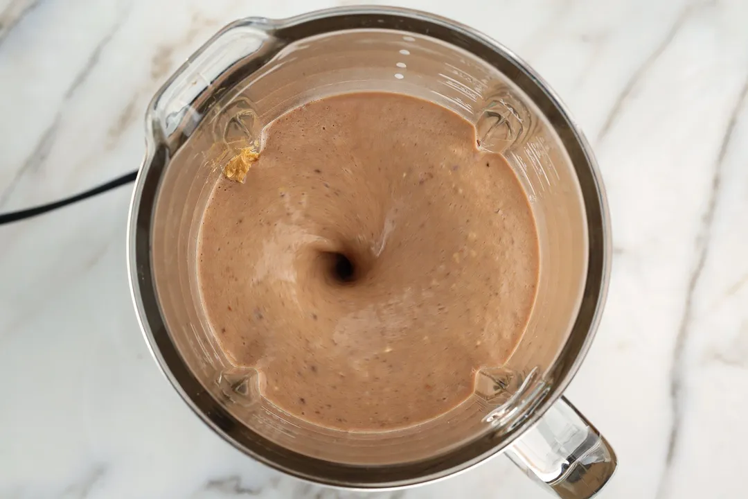 top view of Chocolate Peanut Butter Banana Smoothie are blending in a blender