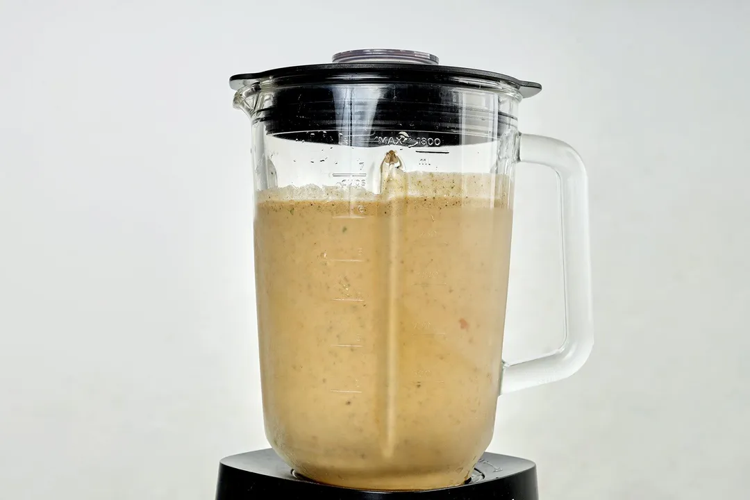 front shot of a blender pitcher of chocolate spinach smoothie