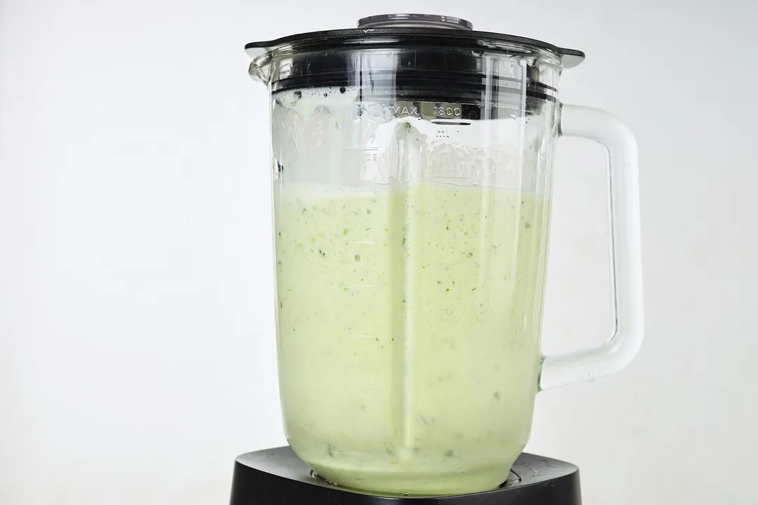 front short of a blender pitcher of cucumber smoothie