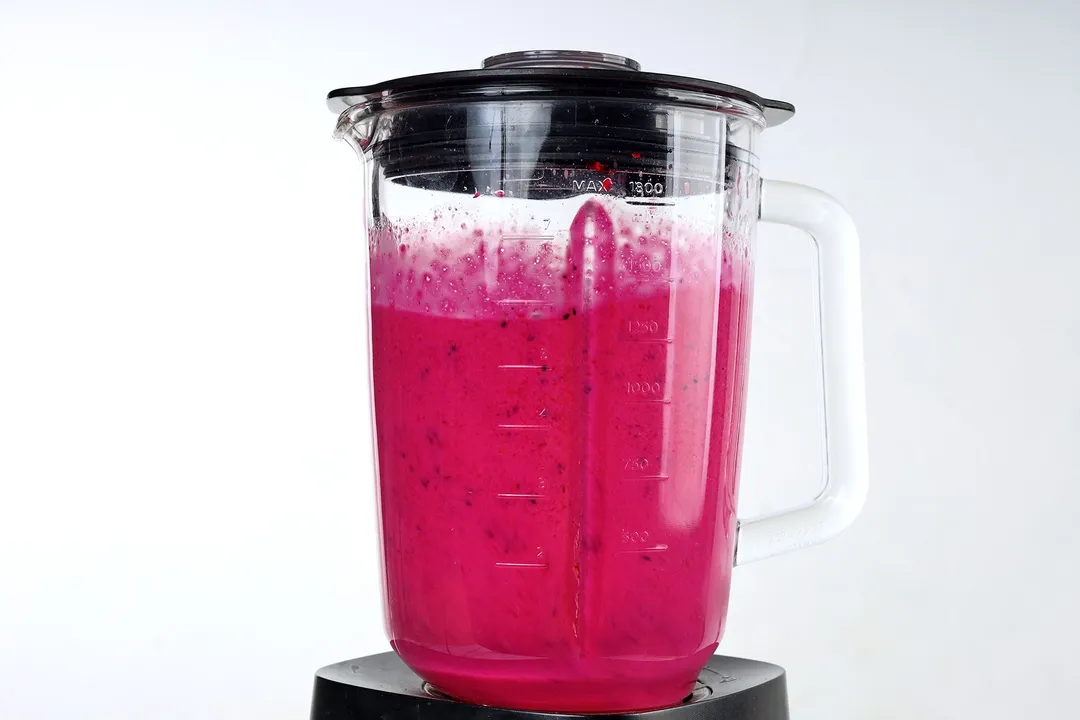 front shot of a blender pitcher of dragon fruit yogurt smoothie