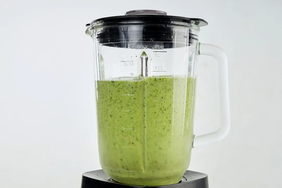 front shot of a blender pitcher of green smoothie