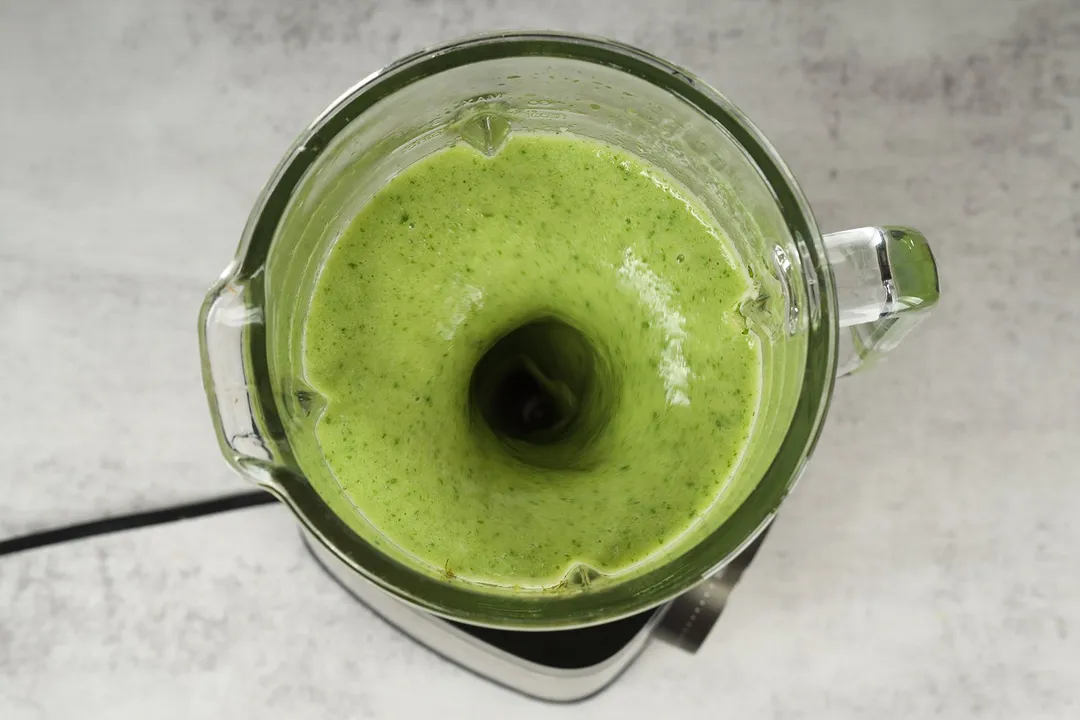 top view of green mojito smoothie in a blender pitcher