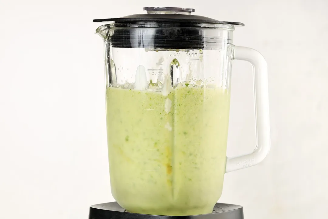 a blender pitcher of kale apple smoothie