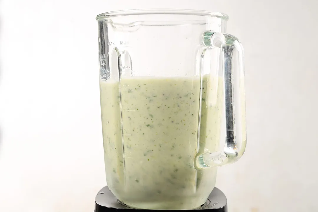 a blender pitcher of kiwi banana smoothie